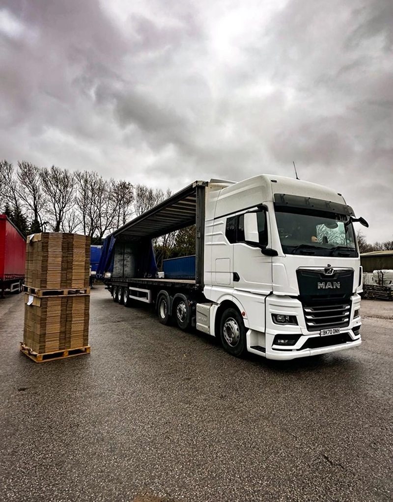 Stacked pallets waiting to load beside a DH Courier artic in the Doncaster yard